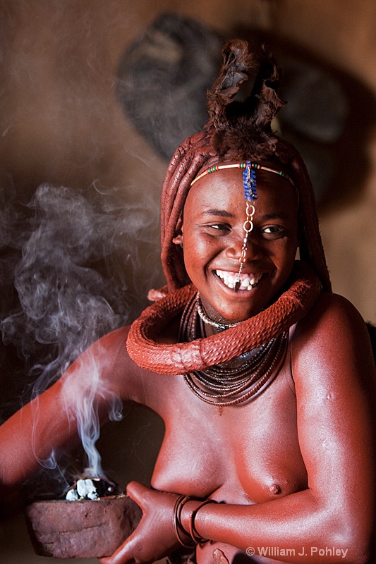 Himba woman bathing with aromatic smoke  (9241) - ID: 9403202 © William J. Pohley