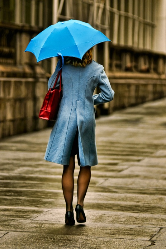 New Yorker woman with light blue umbrella
