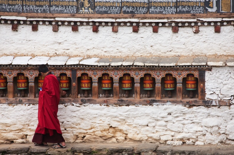 Monk spinning prayer wheels in Bhutan