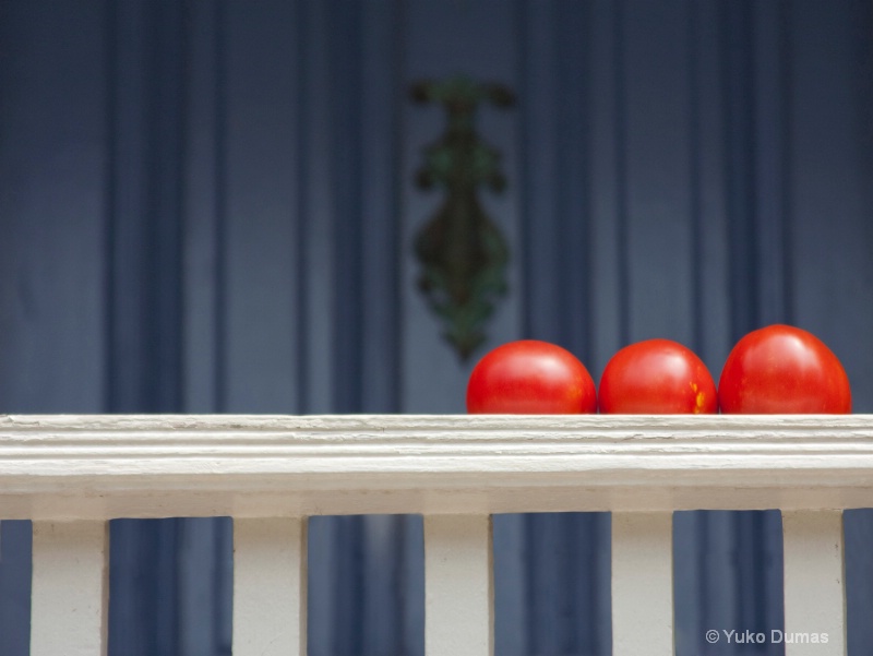 Three tomatoes on the front porch