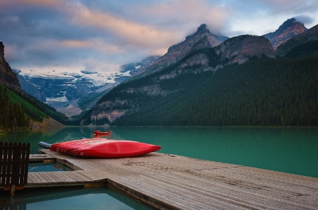 A Dock Of Red Canoes