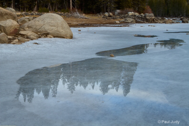 Reflections on icy Lake Alpine