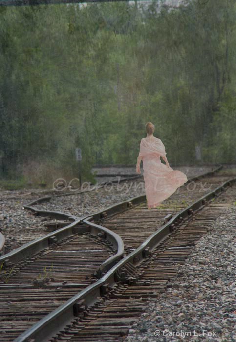 Woman in pink on railroad tracks