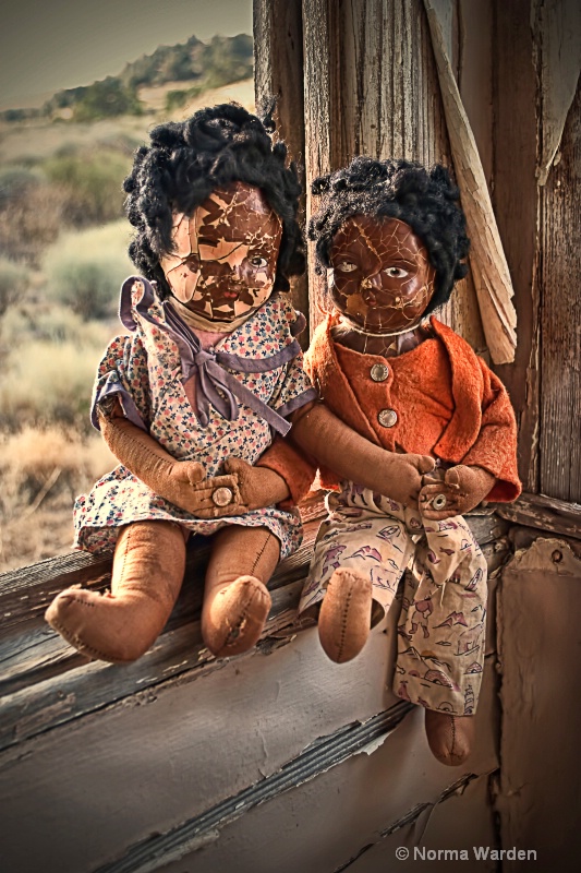Two Dolls on a Window Sill