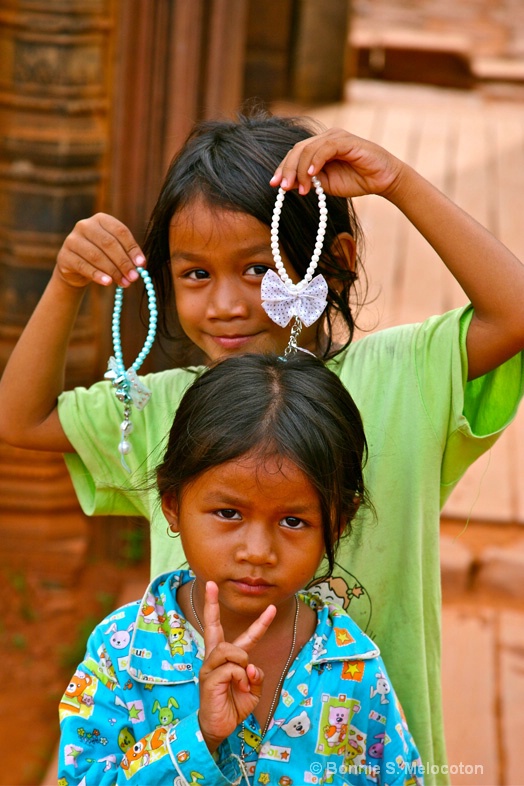 Cambodian girls trying to sell me trinkets