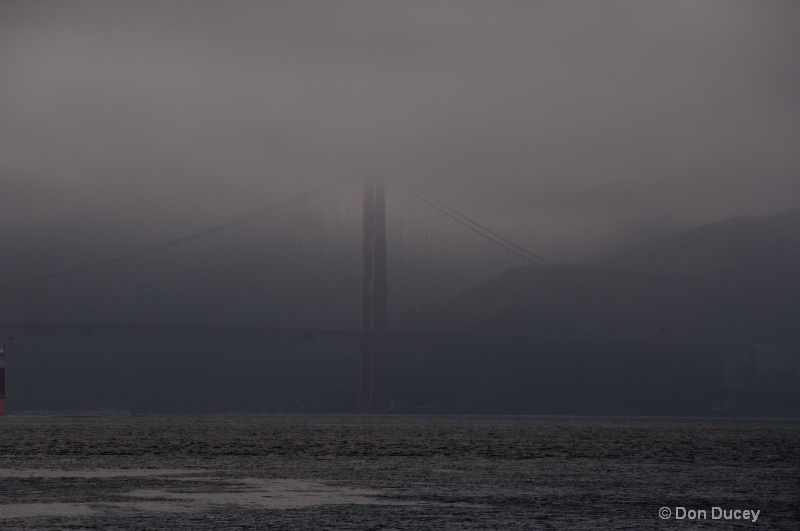 Golden Gate Bridge looming out of the fog