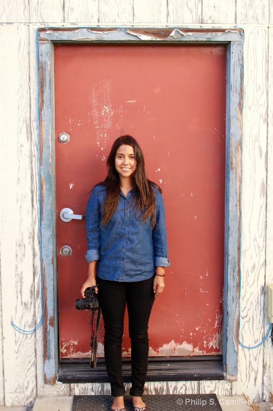 Melissa framed by red door
