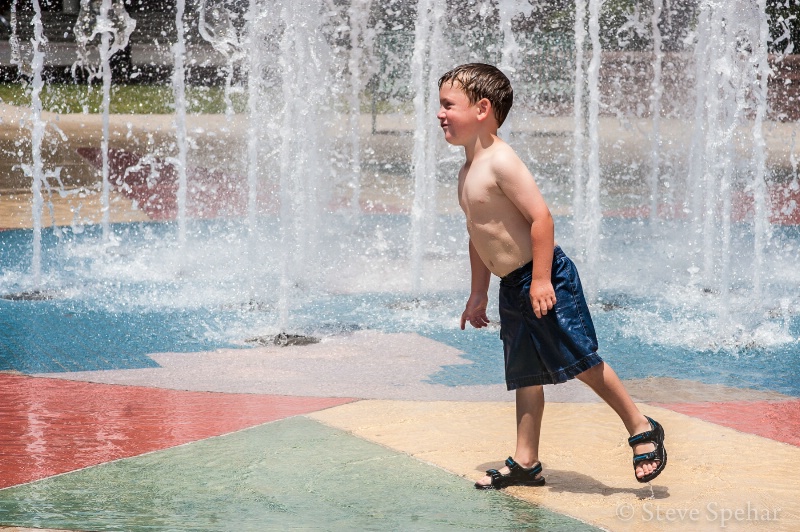 Kid Playing in a Fountain