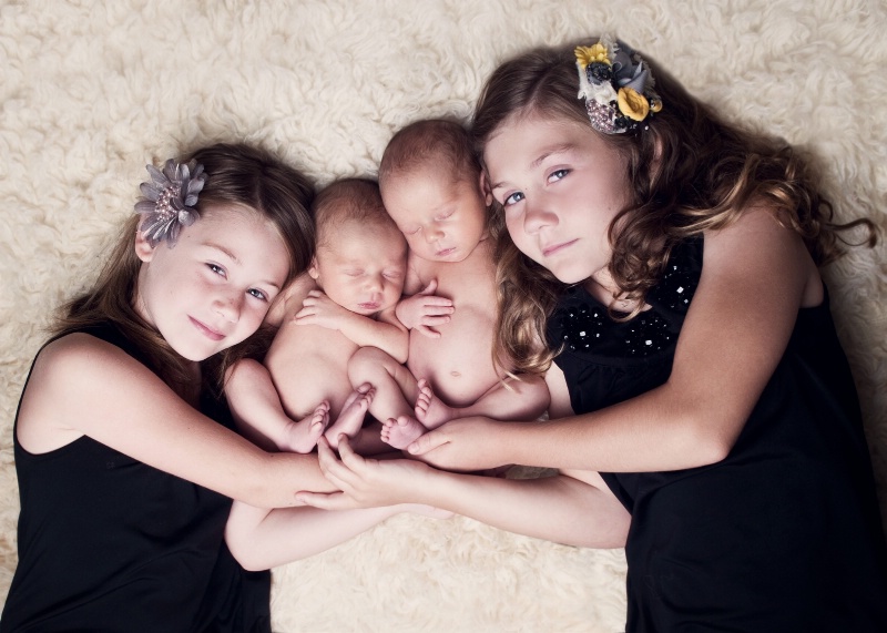 Newborn Twin boys with their big sisters :)