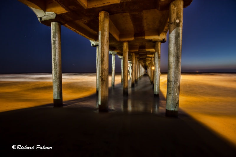 under the pier at night