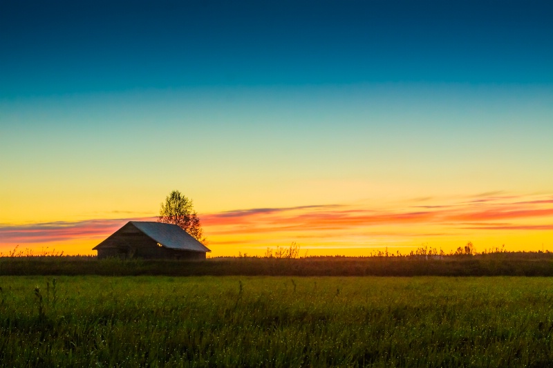 Small Barn House Against The Sunset