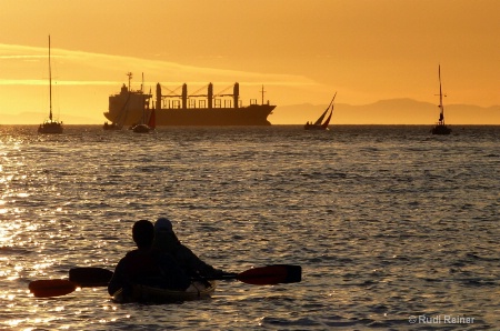 Ocean kayakers at sunset