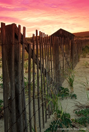 Beach Fence and Shack at Sunset