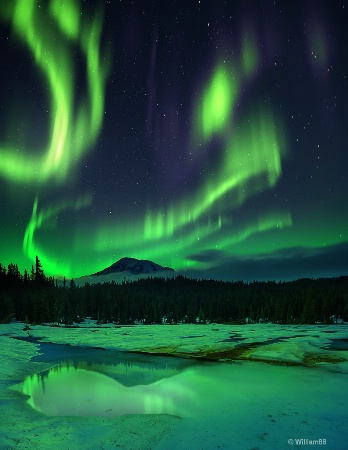Aurora borealis over frozen lake