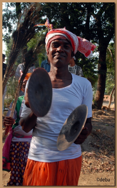 Santhal man playing the brass cymbals...