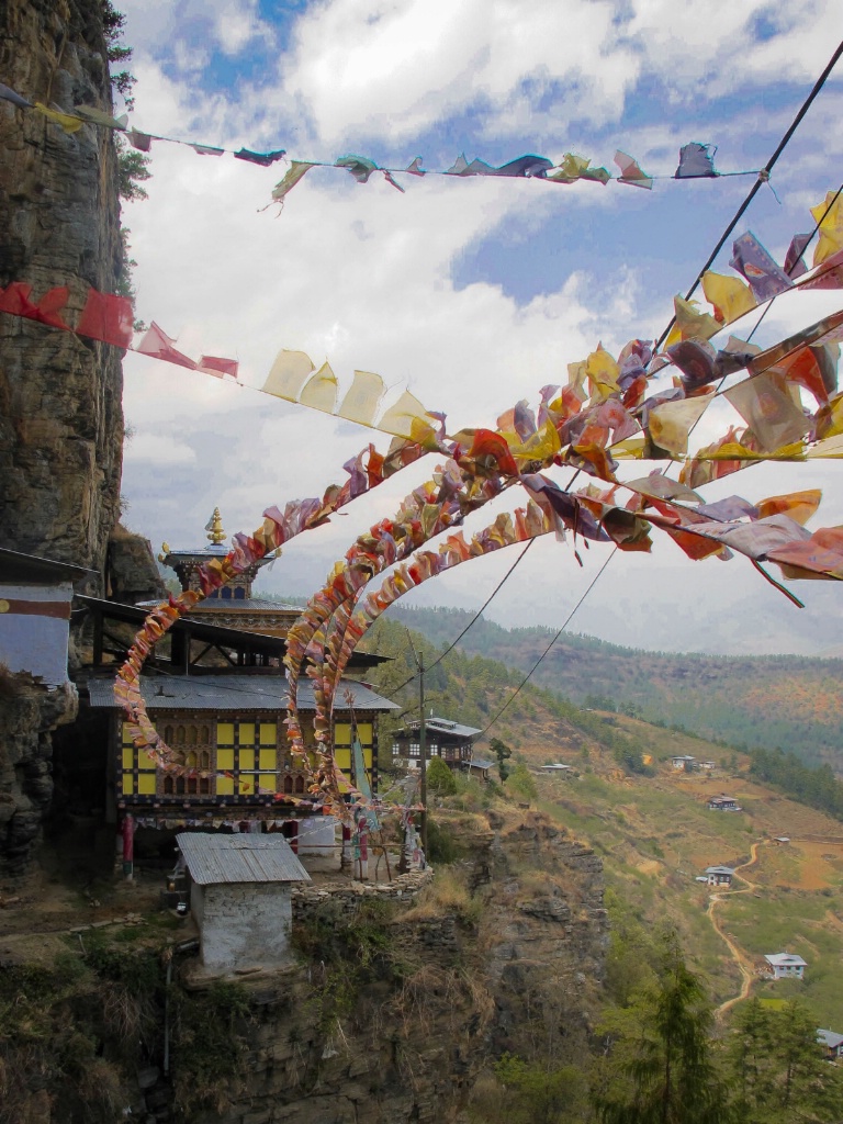 Cliff temple, with prayer flags in the wind
