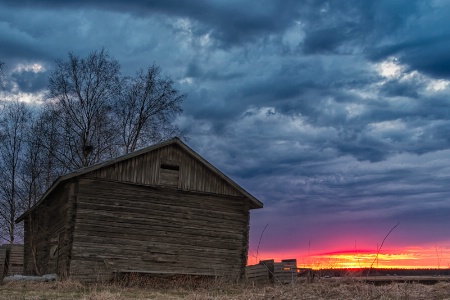 Sunset Behind An Old Barn House