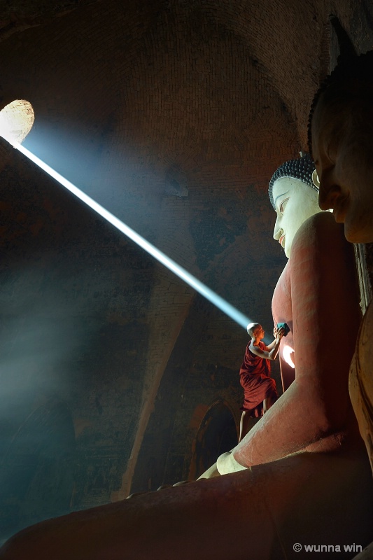 cleaning Buddha statue