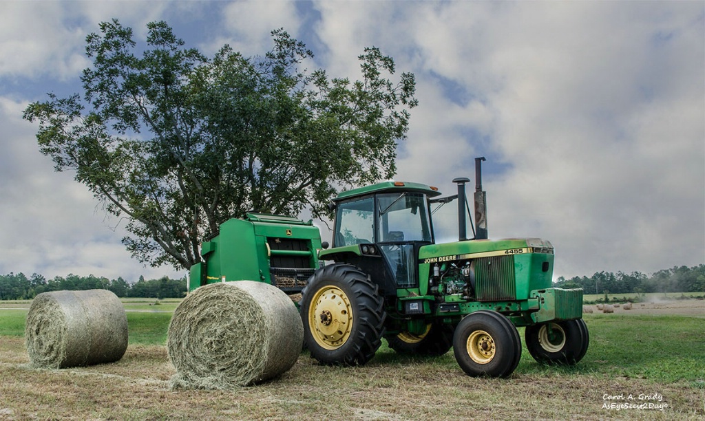 Tractor and 2 bales of hay