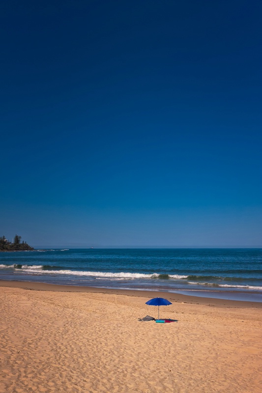 Blue Parasol On A Beach