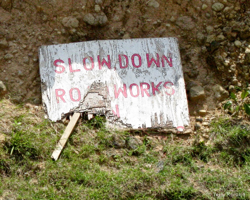 SLOW DOWN ROAD WORKS sign