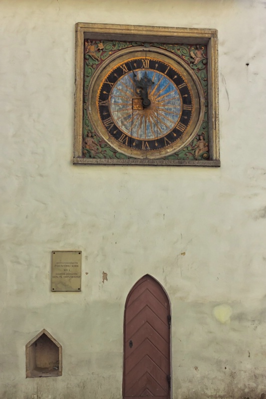 Clock And A Door On An Old Church Wall