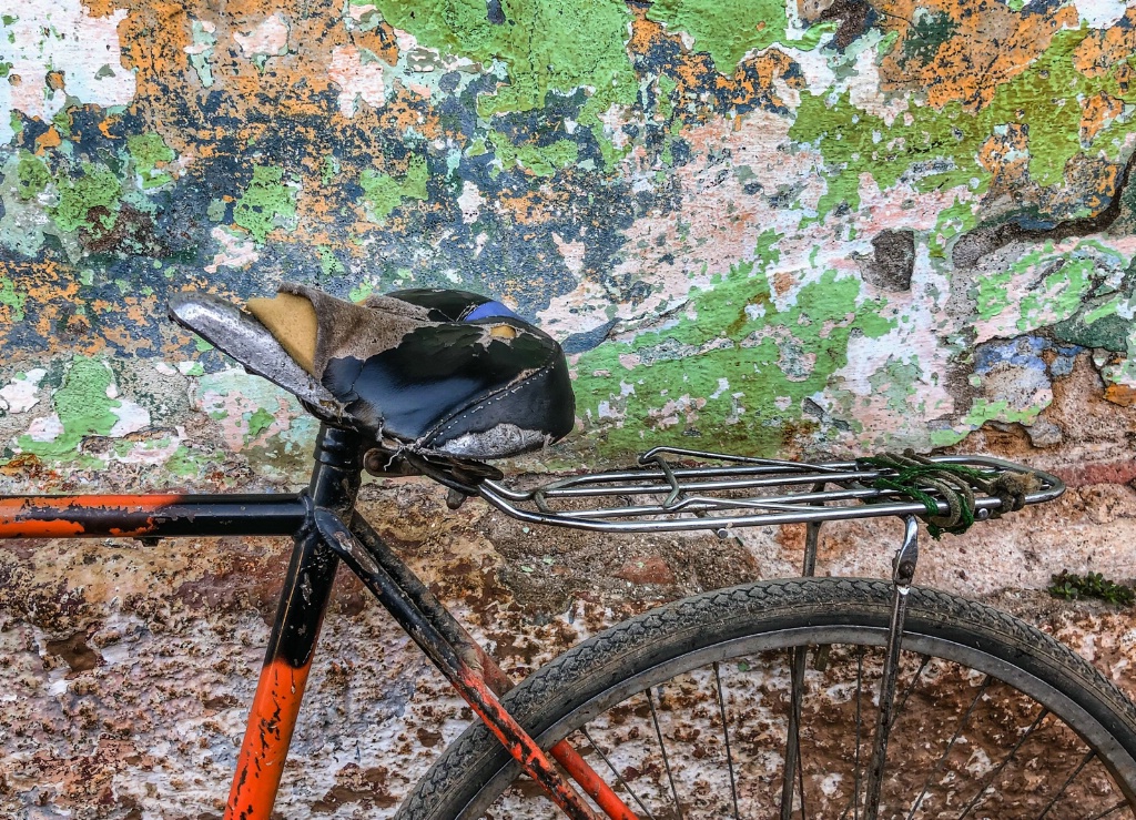 Used Bicycle seat again a decayed wall