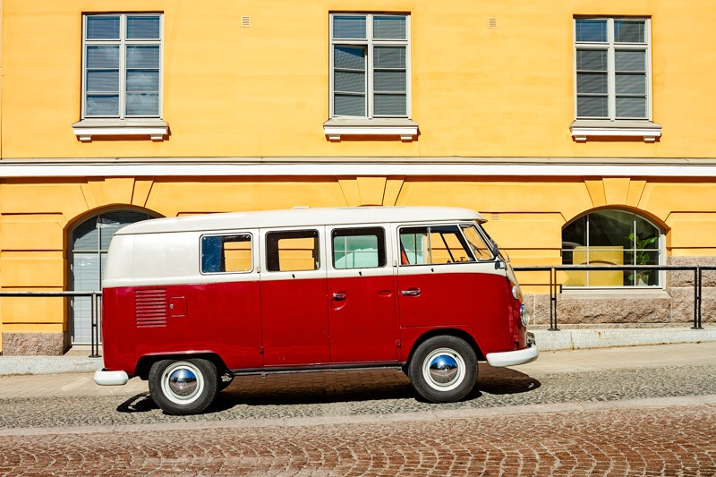 Camper Van Parked By A Yellow Building