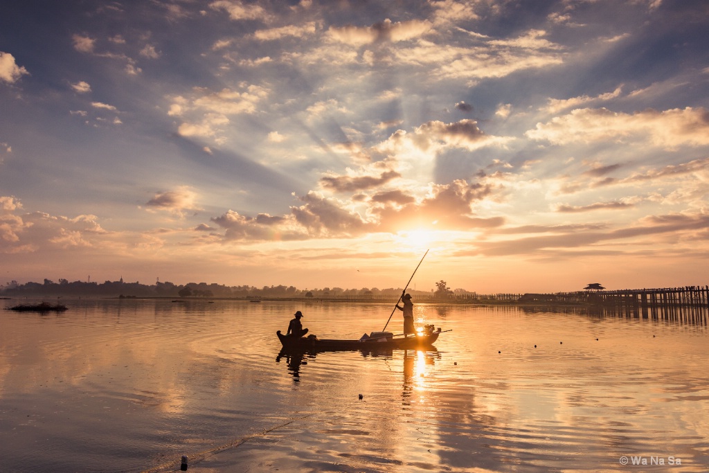 Fishermen under sunrise.