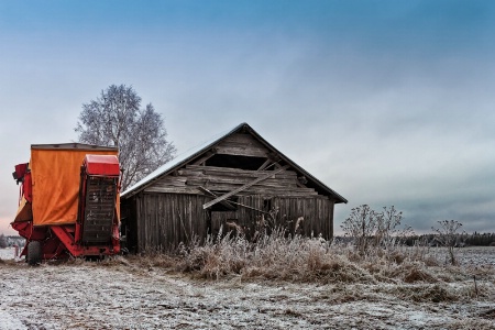 Potato Harvester By An Old Barn