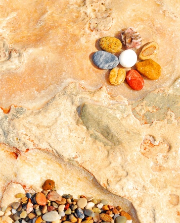 Pebbles on the beach rock.